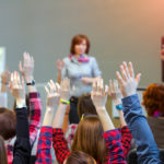 Active Students raising Arms up ready to answer Teachers Question