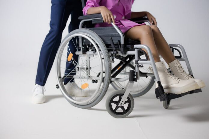 Photo by cottonbro studio: https://www.pexels.com/photo/a-woman-in-a-pink-outfit-and-white-boots-sitting-on-a-wheelchair-8527555/